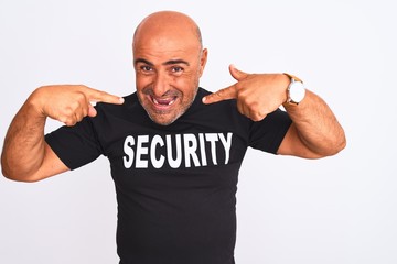 Middle age safeguard man wearing security uniform standing over isolated white background smiling cheerful showing and pointing with fingers teeth and mouth. Dental health concept.