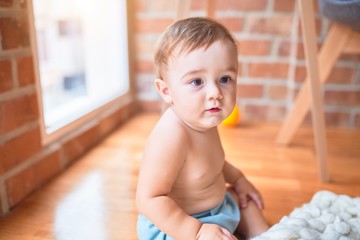 Fototapeta premium Beautiful toddler sitting on the blanket at kindergarten