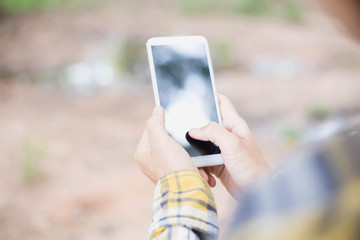 Closeup of hand using smartphone with effects