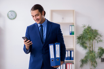 Young male accountant working in the office