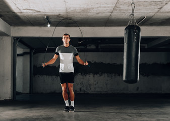 Muscular man skipping exercise with jumping rope