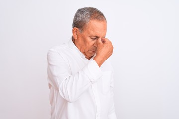 Senior grey-haired man wearing elegant shirt standing over isolated white background tired rubbing nose and eyes feeling fatigue and headache. Stress and frustration concept.