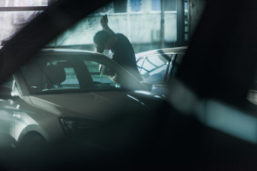 Assaulter breaking a car door with jemmy
