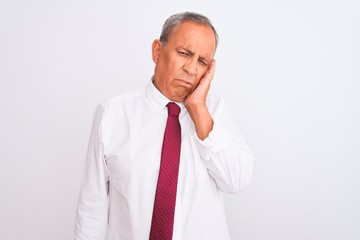 Senior grey-haired businessman wearing elegant tie over isolated white background thinking looking tired and bored with depression problems with crossed arms.