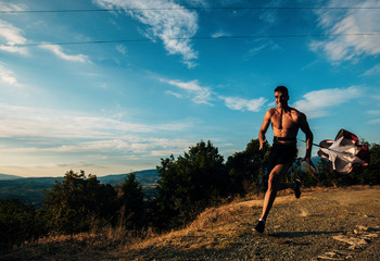 A skyrunner silhouette athlete man trains in the high mountains