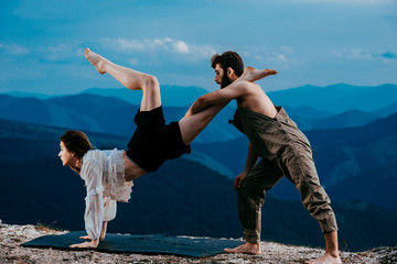 Two modern dancers practicing dancing on the mountain cliff