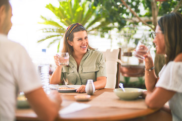Beautiful family sitting on terrace eating foods speaking and smiling