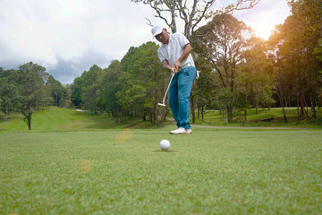 Golfers are playing golf in the evening golf course.