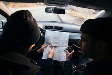 Bank robbers,planning their next hit while holding a gun and counting on a stop watch the time they...
