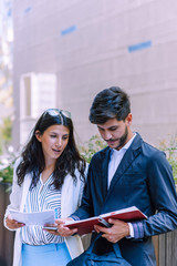 Portrait of an atractive business people holding documnets in their hands