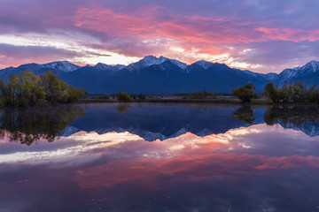 Red skies reflect in the calm pond near St. Ignatius, Montana.
