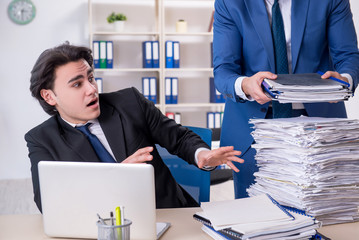 Two male colleagues unhappy with excessive work