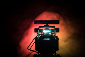 Industrial technology concept, Old electric motor spinning on dark orange background. Broken motor...