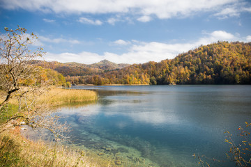 A calm evening landscape with lake and mountains. Amazing view of the Goy-Gol (Blue Lake) Lake among colorful fall forest at Ganja, Azerbaijan.