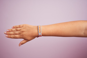 Model arm with beautiful handmade colorful bracelet on wrist
