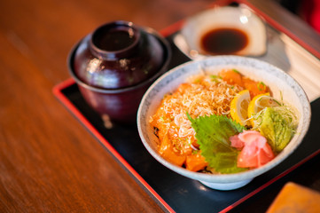 Salmon bowl with miso soup and delicious soy sauce