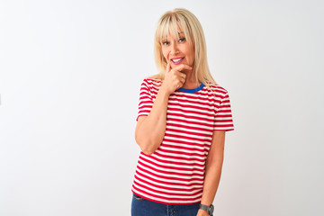 Middle age woman wearing casual striped t-shirt standing over isolated white background looking...