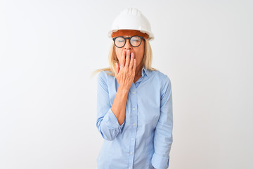Middle age architect woman wearing glasses and helmet over isolated white background bored yawning tired covering mouth with hand. Restless and sleepiness.