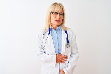 Middle age doctor woman wearing glasses and stethoscope over isolated white background with hand on stomach because nausea, painful disease feeling unwell. Ache concept.