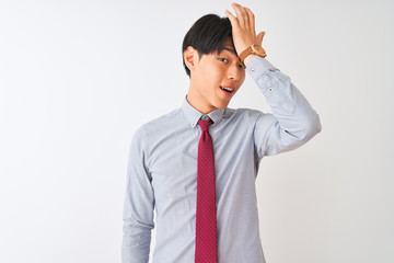 Chinese businessman wearing elegant tie standing over isolated white background surprised with hand...
