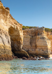 Fototapeta premium Beautiful landscape of Algarve, Portugal coast with sandstone cliffs, beach and ocean under cloudless blue sky