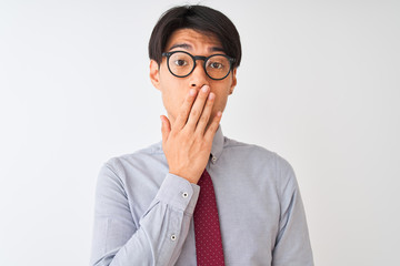 Chinese businessman wearing tie and glasses standing over isolated white background cover mouth with hand shocked with shame for mistake, expression of fear, scared in silence, secret concept