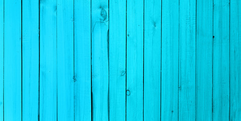 Background of wooden narrow vertical boards of cyan color. The blue texture of the wood. Used for...
