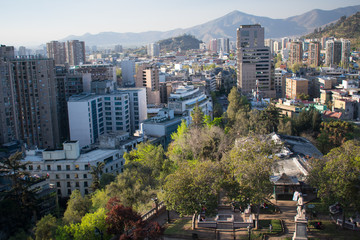 Fototapeta premium Panorama of Downtown Santiago Chile with Chilean Flag from Santa Lucia Hill