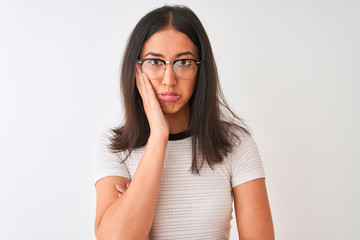 Chinese woman wearing casual t-shirt and glasses standing over isolated white background thinking looking tired and bored with depression problems with crossed arms.