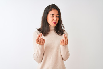 Fototapeta premium Beautiful chinese woman wearing turtleneck sweater standing over isolated white background doing money gesture with hands, asking for salary payment, millionaire business