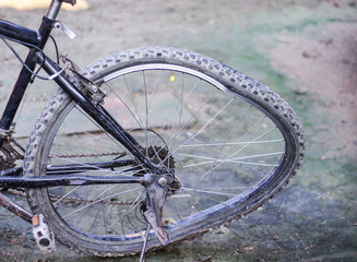 Broken spoke and damage crooked bicycle wheel from crash on the ground background