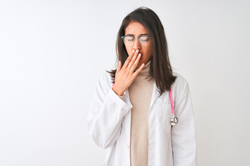 Chinese doctor woman wearing coat and pink stethoscope over isolated white background bored yawning tired covering mouth with hand. Restless and sleepiness.