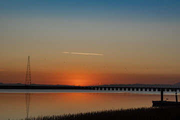 Fototapeta na wymiar Sunrise over the Napa river along the railroad bridge