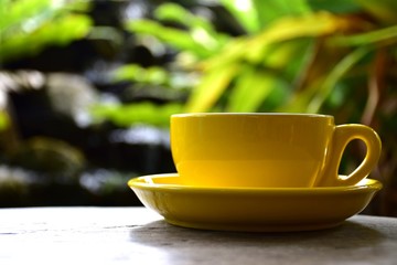 Cup of hot coffee on the wooden floor in the morning