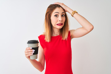 Young beautiful redhead woman drinking take away coffee over isolated white background stressed with hand on head, shocked with shame and surprise face, angry and frustrated. Fear and upset