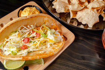 Homemade Baja Fish Tacos with Mango Salsa and Chips. Mixed mexican food: Guacamole, nachos, fajita, meat tacos. Top view. Tex-mex cuisine. Assorted appetizers. Cuisine of Mexico