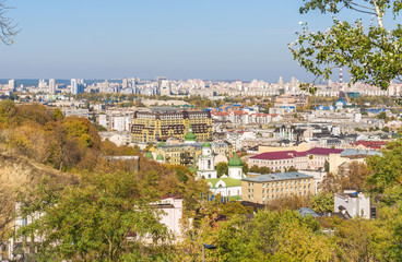 Fototapeta premium View of the multi-colored roofs of new apartment buildings on Vozdvizhenka in a new residential area in the ancient historic district of Podol, Kiev, Ukraine. In the background is Obolon.