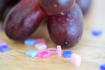 macro view red grapes on wooden board