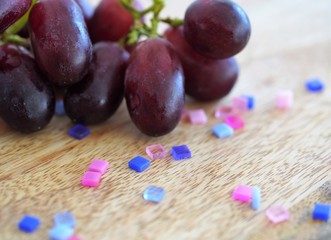 fresh grapes and colorful mosaic tiles on wooden table