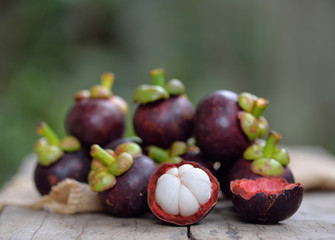 Mangosteen fruit on a wooden table.