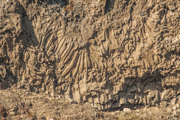 Basalt rock formations and lava columns and arches of Hjálparfoss waterfall (part of Fossá rivera) in south Iceland