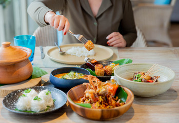 A woman eating sea food in Thai cousin