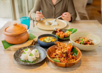 A woman eating sea food in Thai cousin