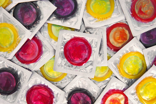 Colorful condom on background. large number of condoms. concept of safe sex. lots of rubber condoms. bunch of objects