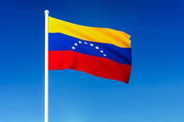 Fototapeta na wymiar Waving flag of Venezuela on the blue sky background
