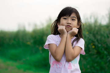 Fototapeta premium Asian child cute girl Play happy smile on Green lawn