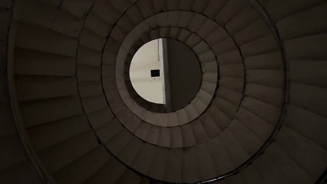 Spiral Staircase in a Lighthouse, Looking Up the Interior Stairwell of the Querandi Lighthouse in Villa Gesell, Argentina. Dust Particles in the Air. Zoom Out. 