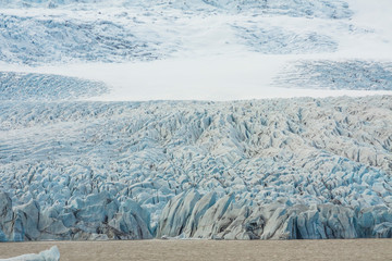Tongue of the Brei&eth;amerkurj&ouml;kull glacier as it retreats into glacier lagoon J&ouml;kuls&aacute;rl&oacute;n leaving floating icebergs (Vatnaj&ouml;kull National Park in Iceland)