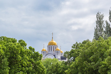 Fototapeta na wymiar Domes of St. George Church in greenery, Samara