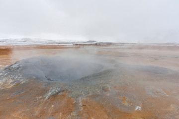 Panorama of geothermal area Hverarönd (Hverir), situated by the orange-red clay coloured tuff mountain Namafjall south of Námaskarð in Iceland, with details and patterns